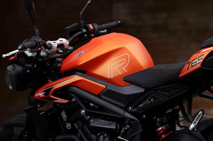 A small TFT display with Bluetooth connectivity is also part of the package Triumph Street Triple R in orange tank shot